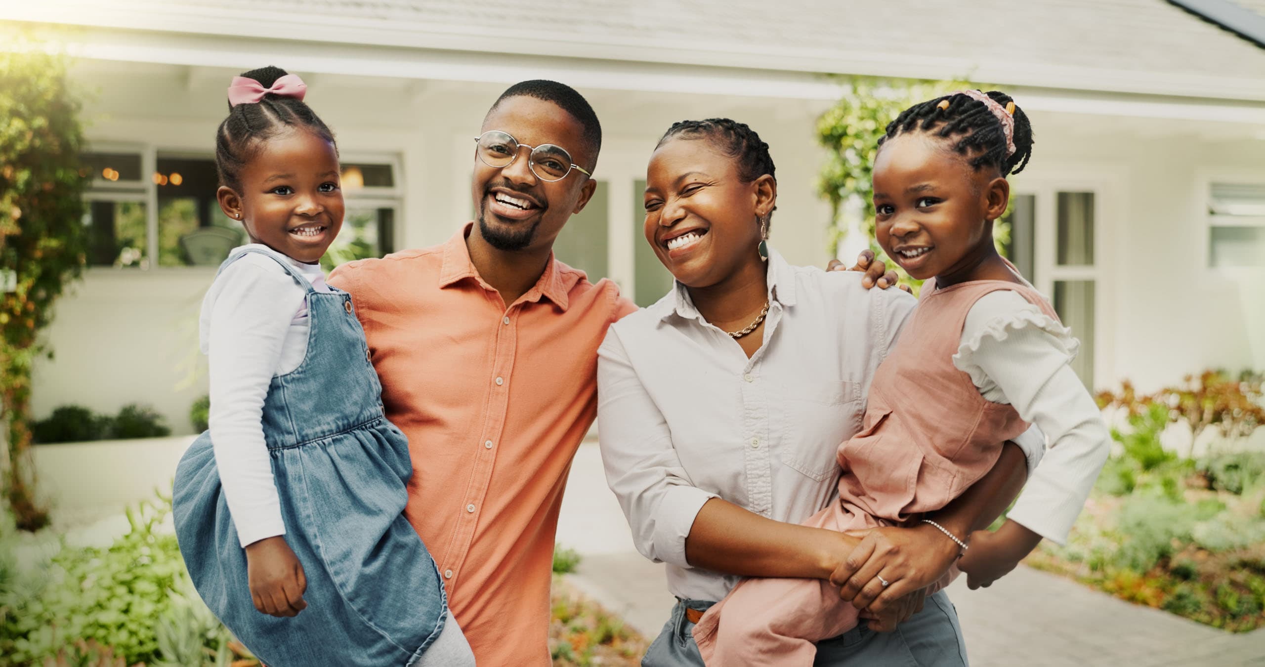 A diverse family standing in front of their new Miami-Dade home